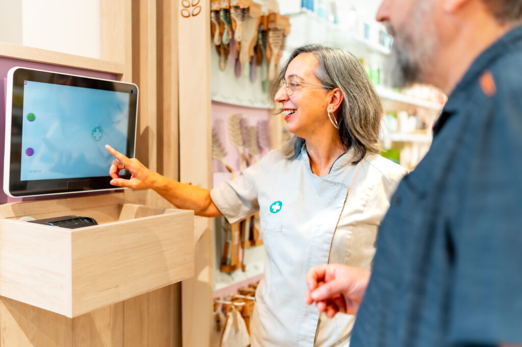 woman pharmacist looking at tech screen