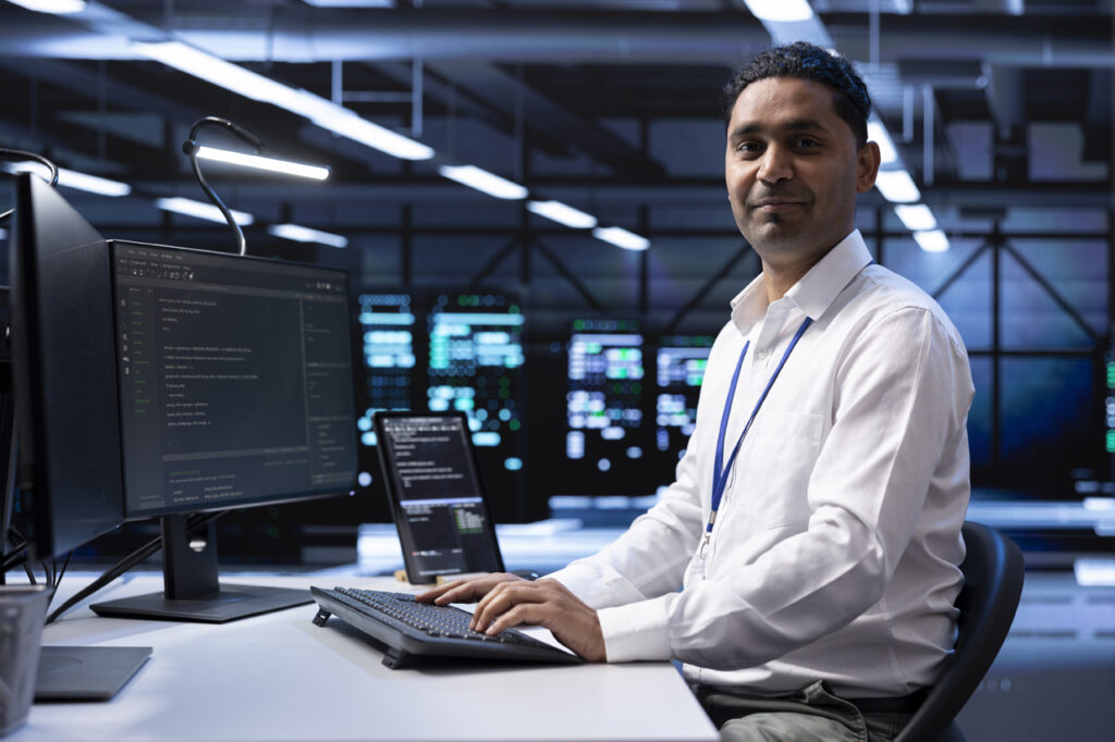 software developer smiling and typing on keyboard