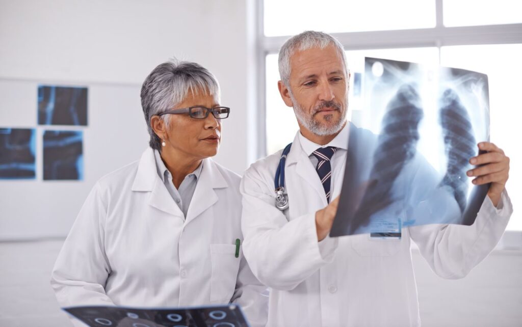 two doctors analyzing an AI scan of an xray