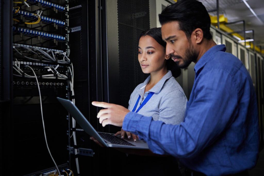 two IT members checking on a server