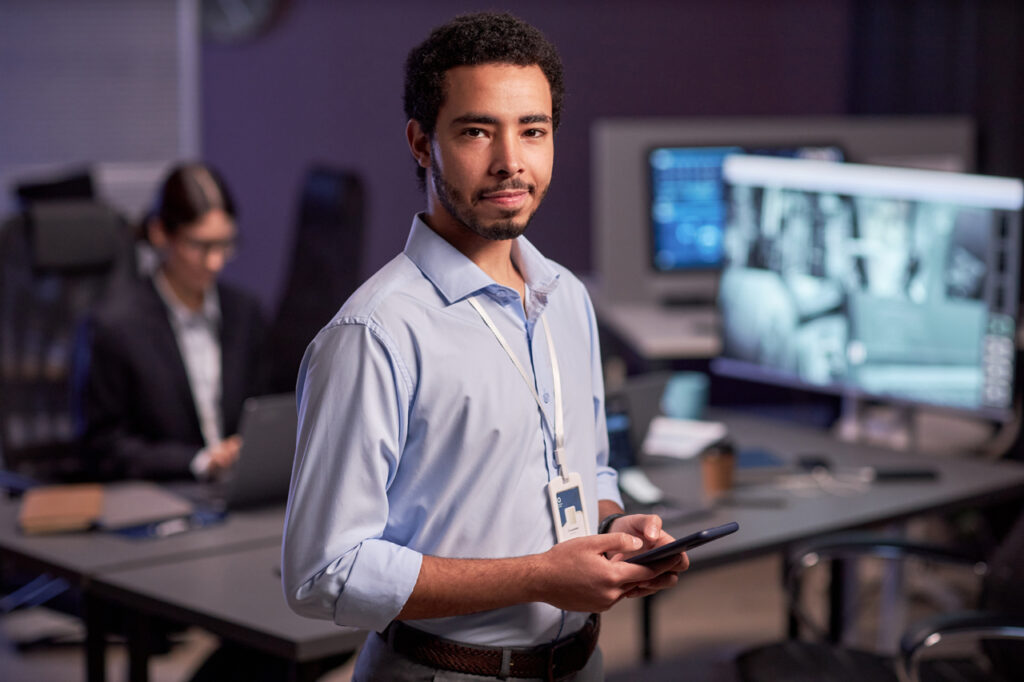 IT specialist sending email on phone