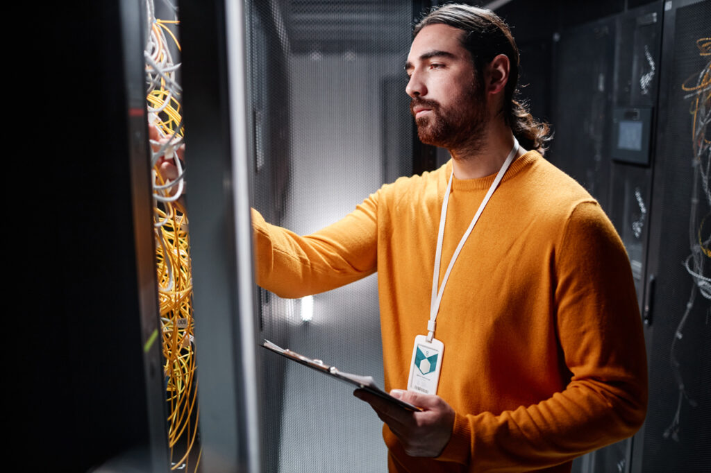 IT support man checking on cables