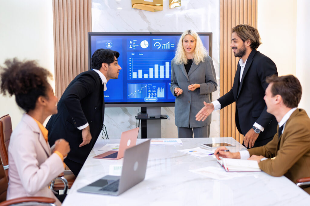 Employee on job corporate Business colleagues around the table look presentation from large screen