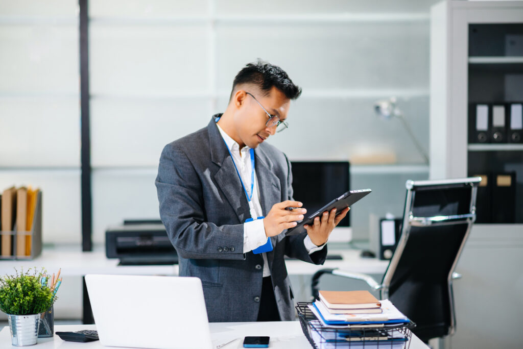 Mature business man executive manager looking at laptop watching online webinar training or having virtual meeting video conference doing market research working in office.