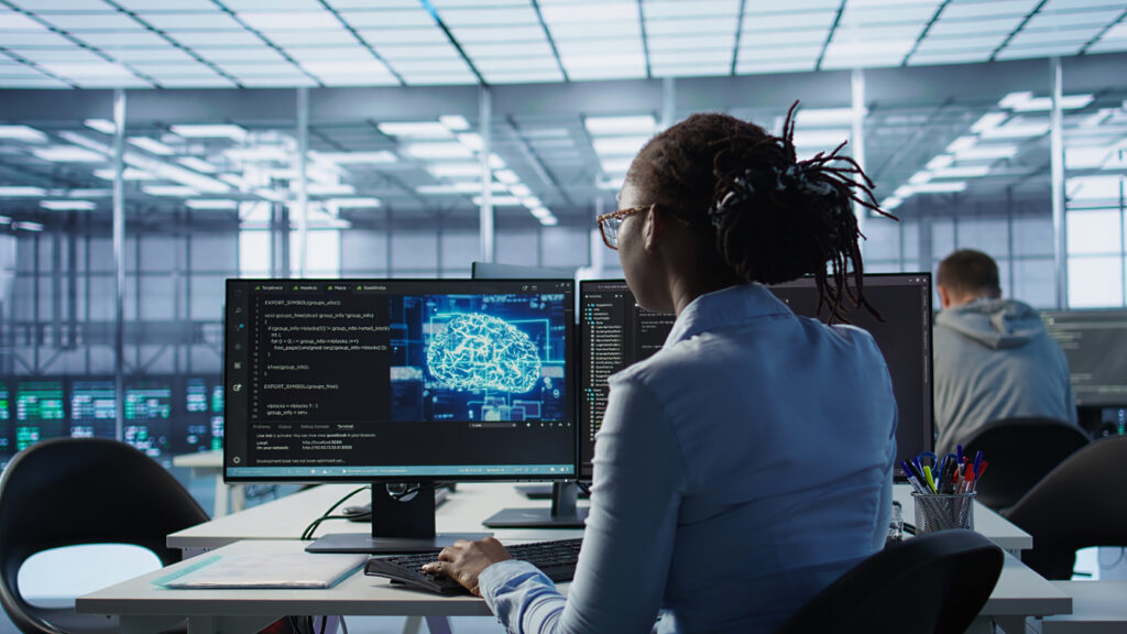 Engineer typing on computer in server hub, monitoring data center energy consumption using AI software. Technician inspecting rackmounts in server room using artificial intelligence tech, camera B